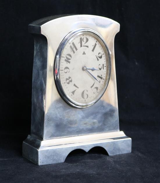 A George V silver mounted mantel timepiece with oval Arabic dial, 5.75in.